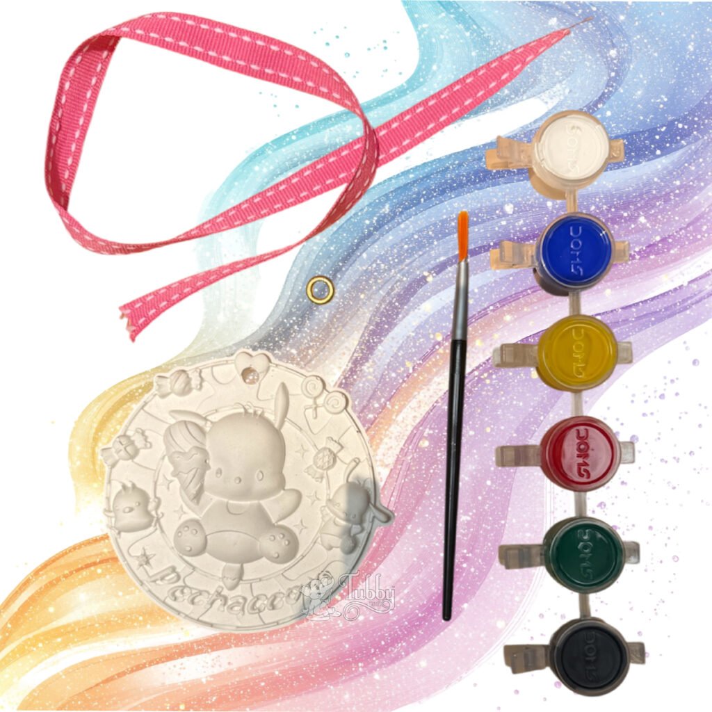 An all-in-one DIY craft kit for children displayed against a colorful, swirly pastel background. The kit features a white, 4-inch round embossed keepsake plate with a 3D design of the cartoon dog character Pochacco holding an ice cream cone, with the name "Pochacco" spelled along the bottom border. The kit also includes a fine-tip paintbrush, a strip of six vibrant acrylic paint pots, a pink ribbon with white contrast stitching, and a single golden metal eyelet.